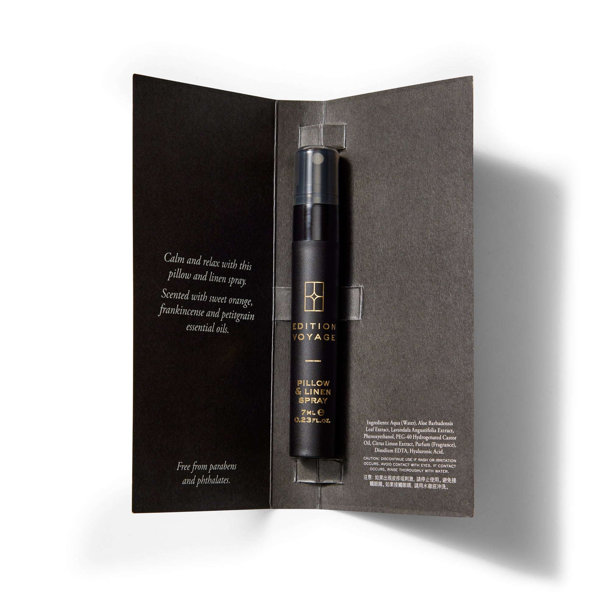 An Edition Voyage Pillow & Linen Spray vial mounted inside its open black presentation card.