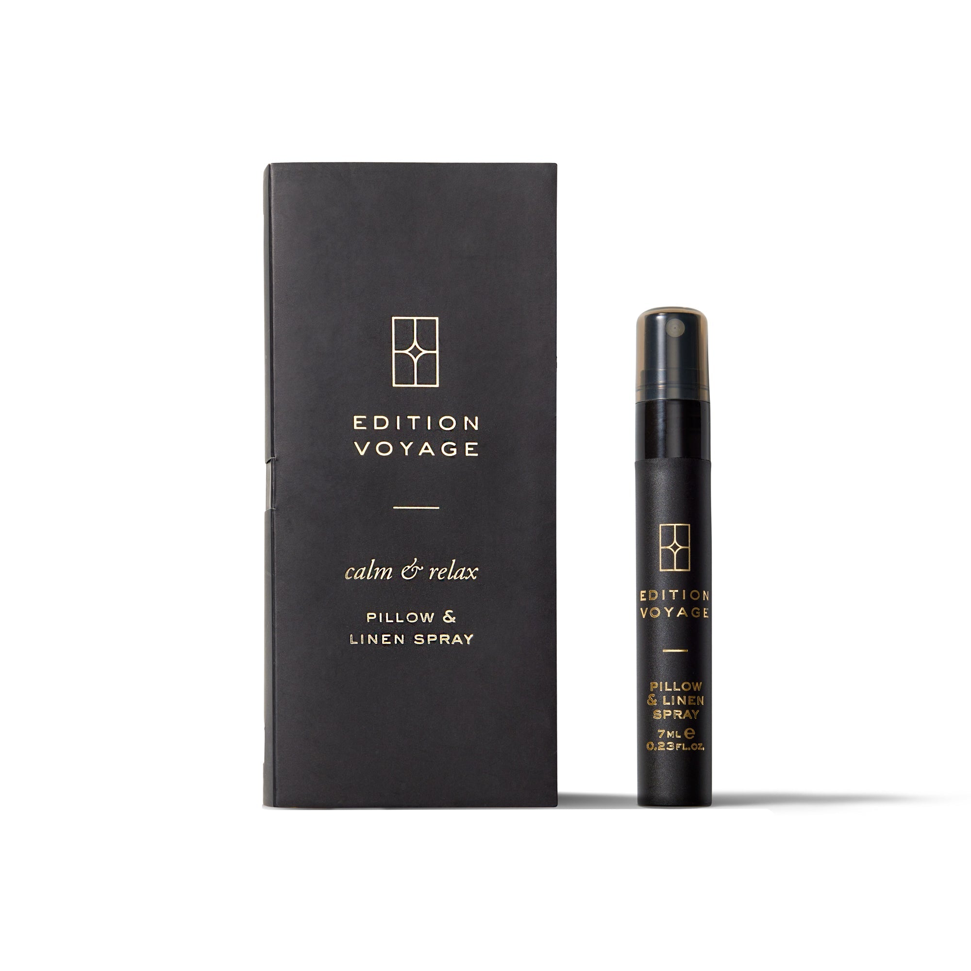 An Edition Voyage calm & relax Pillow & Linen Spray bottle standing next to its black packaging box.